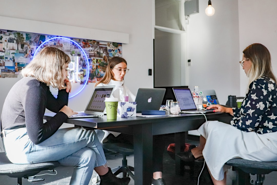Small business team working with laptops in a modern office using managed internet